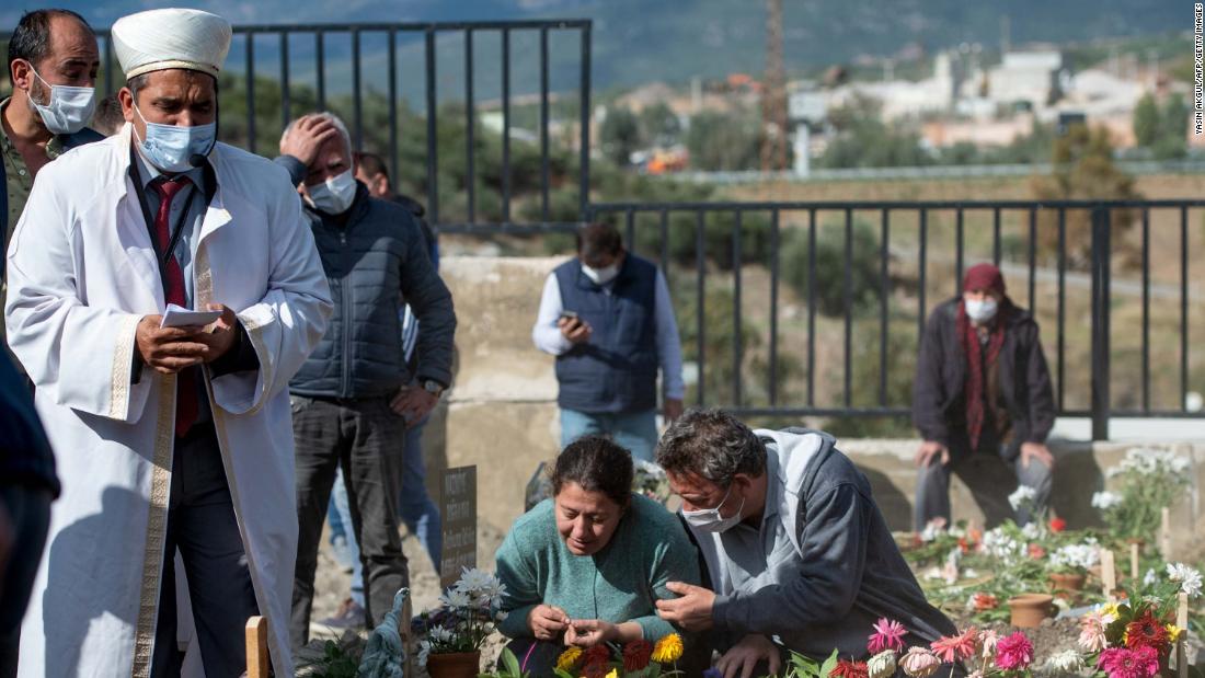 An imam prays in Izmir as people attend the November 1 funeral of Bayram and Hatice Dogruya, a married couple killed in the earthquake.