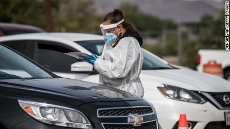 An attendant talks to a person waiting in their car at a coronavirus testing site at Ascarate Park on October 31 in El Paso, Texas.