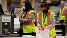 Workers whittle down piles of uncounted ballots in key states