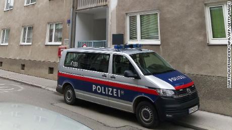 A police car stands in front of a residential building in St. Poelten, Austria, where raids were carried out Tuesday in connection with the Vienna attack.