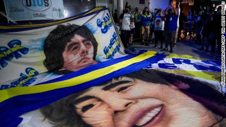 Supporters Diego Maradona gather outside the hospital where he underwent successful brain surgery for a blood clot.