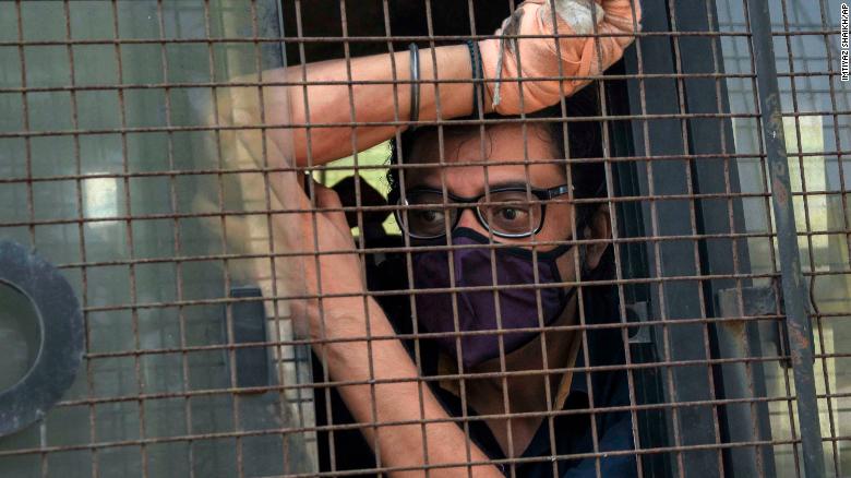 Indian television news anchor Arnab Goswami sits inside a police vehicle after he was taken to court following his arrest in Mumbai on November 4. 