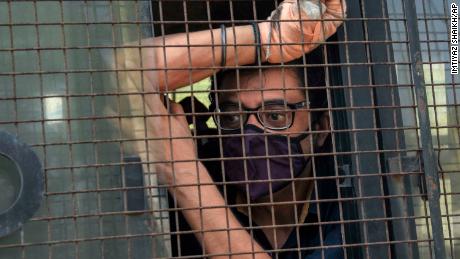 Indian television news anchor Arnab Goswami sits inside a police vehicle after he was taken to court following his arrest in Mumbai on November 4. 