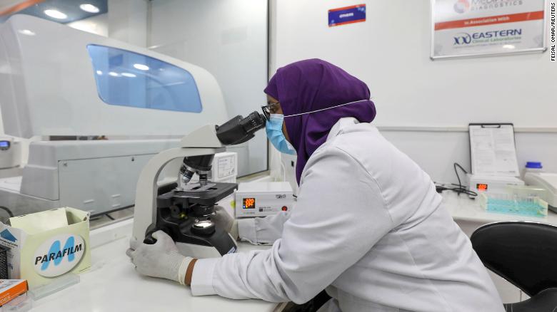 Aisha Abdi Mohamed, a laboratory technician, uses a microscope inside the Medipark Diagnostics lab that runs tests for the coronavirus disease (COVID-19), in Mogadishu, Somalia October 14, 2020.