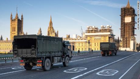 Military vehicles cross Westminster Bridge on March 24, 2020, after army personnel delivered a consignment of medical masks to St Thomas' Hospital, London.
