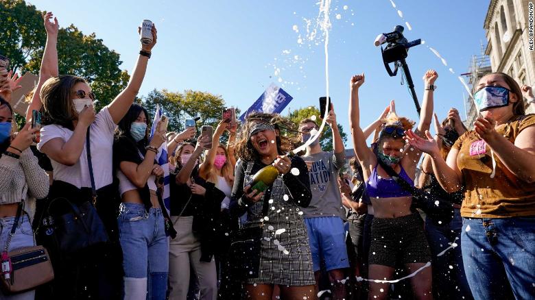 Amanda Madden sprays champagne as people celebrate at Black Lives Matter Plaza on November 7, 2020.