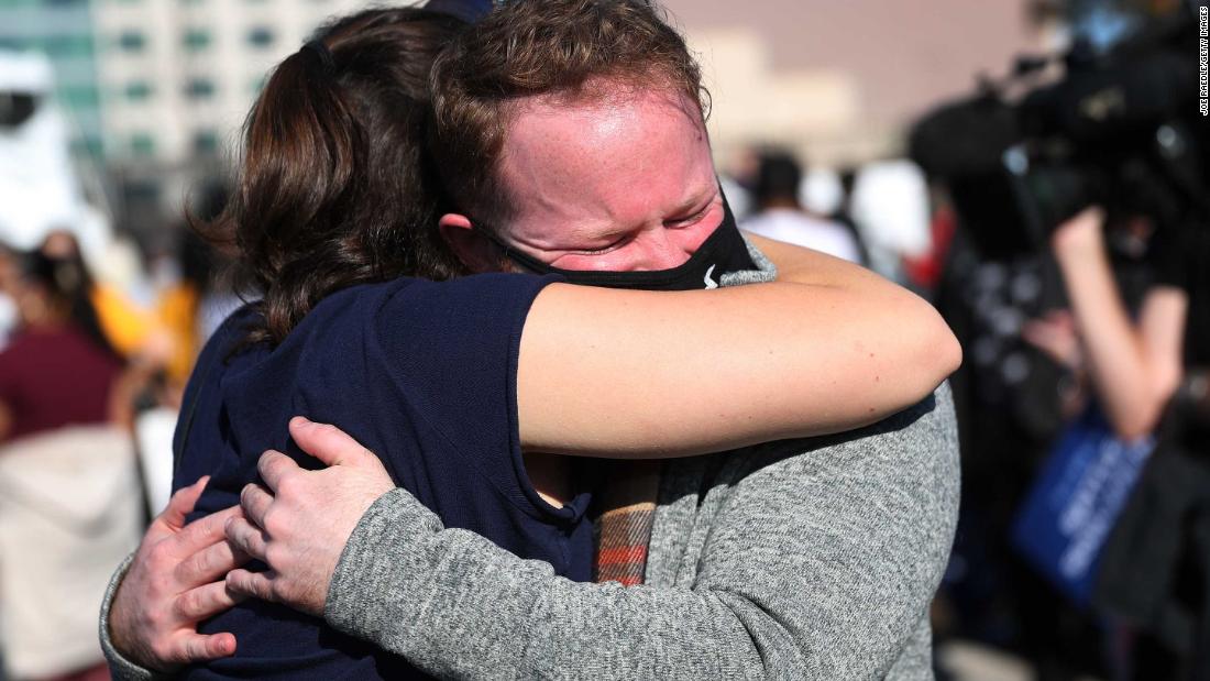 Gabi Poletaev and Michael Crowley hug outside the Chase Center in Wilmington, Delaware.