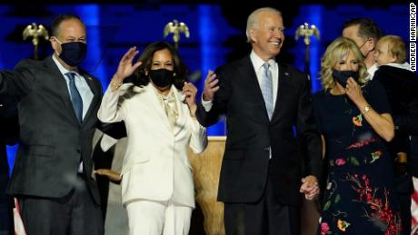 From left, Doug Emhoff, husband of Vice President-elect Kamala Harris, Harris, President-elect Joe Biden and his wife Jill Biden on stage together, Saturday, Nov. 7, 2020, in Wilmington, Del.(AP Photo/Andrew Harnik, Pool)