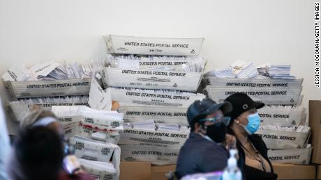 Security envelopes for absentee ballots sit in stacked boxes as Fulton County workers count absentee ballots on November 6. 