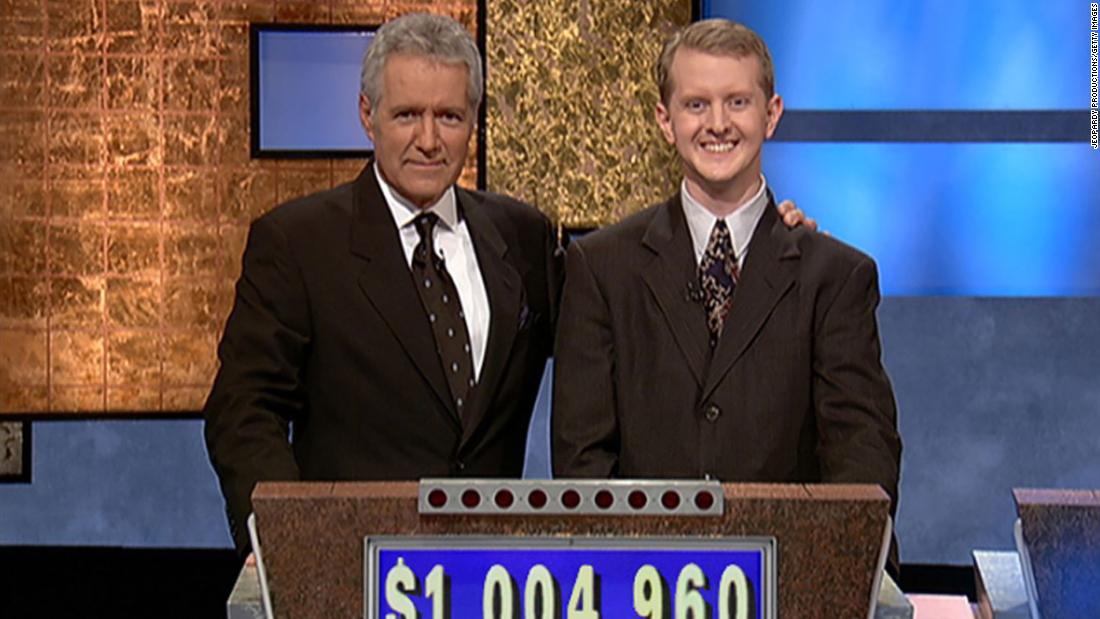 Trebek poses for a photo on set with contestant Ken Jennings after his earnings from his record-breaking streak on the game show surpassed $1 million on July 14, 2004.