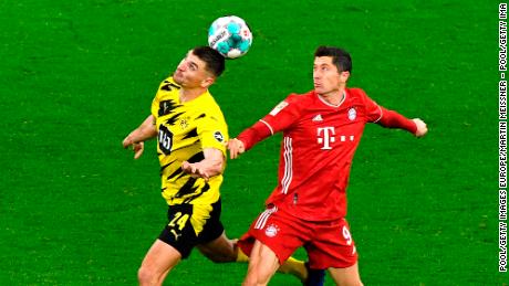 Dortmund&#39;s Thomas Meunier, left, and Bayern&#39;s Robert Lewandowski challenge for the ball during &quot;Der Klassiker.&quot;