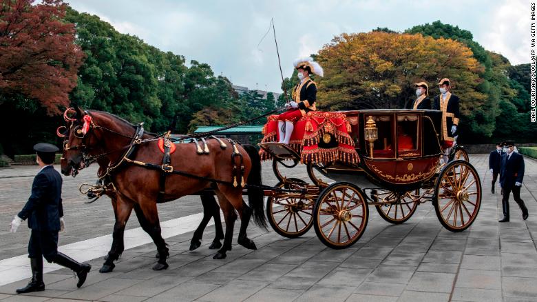 Crown Prince Akishino of Japan leaves the Imperial Palace in a horse drawn carriage in Tokyo on November 8.