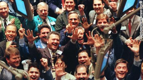 Traders cheer on the floor of the New York Stock Exchange in March 1999 as the Dow first reached the 10,000 mark.  By the end of the month, this will close above the level.