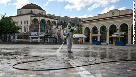 A municipal worker disinfects the empty Monastiraki square in central Athens. Greece, on the first day of a three-week lockdown in November.
