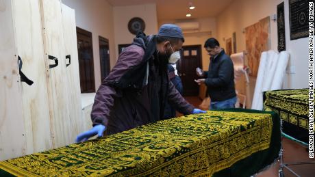 A casket of a Muslim man who died from what was believed to be the coronavirus is prepared for burial at a busy Brooklyn funeral home on May 9, 2020.