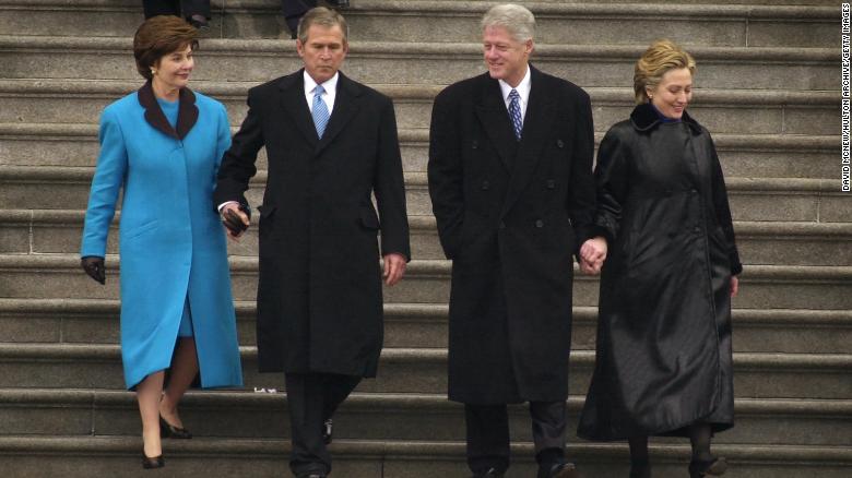 President George W. Bush, first lady Laura Bush and former President Bill Clinton and first lady Hillary Rodham Clinton exit the Capitol building following the presidential inauguration ceremony January 20, 2001.