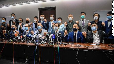 Pro-democracy lawmakers join hands at the start of a press conference in a Legislative Council office in Hong Kong on Wednesday.