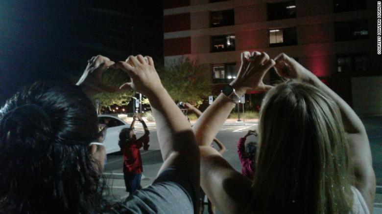 The family of Daniel Morales prayed outside of the hospital every night, folding their hands into the shapes of hearts and lifting them into the air, for nearly a month before he succumbed to Covid-19. (Credit: Minvera Morales)