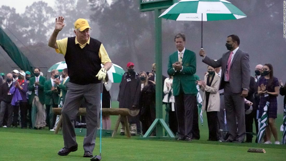 Honorary starter Jack Nicklaus waves to the few patrons gathered for his ceremonial tee shot on the first hole ahead of the first round.