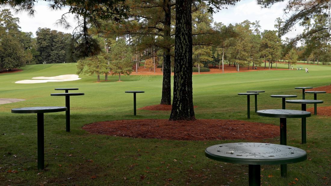 Empty tables are seen near the course during the first round. Patrons have not been allowed to attend the tournament due to the coronavirus pandemic. 