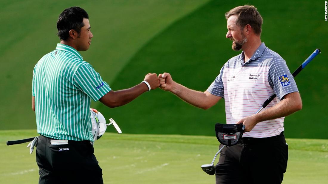 Webb Simpson (right) fist pumps Hideki Matsuyama (left) on the ninth hole after their first round.