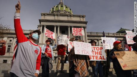 Dozens of people calling for stopping the vote count in Pennsylvania due to alleged fraud against President Donald Trump gather on the steps of the State Capitol on November 5 in Harrisburg, Pennsylvania. 