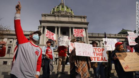 HARRISBURG, PENNSYLVANIA - NOVEMBER 05: Dozens of people calling for stopping the vote count in Pennsylvania due to alleged fraud against President Donald Trump gather on the steps of the State Capital on November 05, 2020 in Harrisburg, Pennsylvania. The activists, many with flags and signs for Trump, have made allegations that votes are being stolen from the president as the race in Pennsylvania continues to tighten in Joe Biden&#39;s favor. (Photo by Spencer Platt/Getty Images)