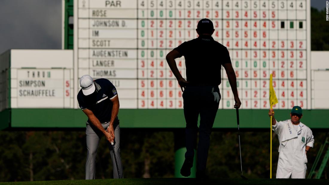Patrick Cantlay watches as Dustin Johnson putts on the 17th hole during the first round of the Masters.