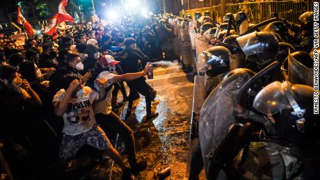 Dozens of people clashed with protesters and police in Peru amid political crisis