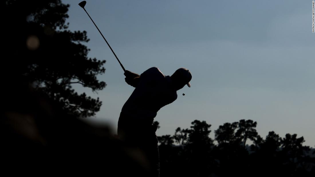 Dustin Johnson of the United States plays his shot from the 10th tee during the third round of the Masters at Augusta National Golf Club. He leads by four on 16-under.
