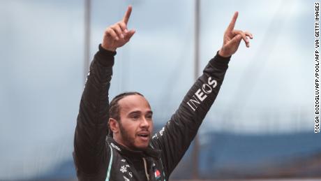 Mercedes&#39; British driver Lewis Hamilton celebrates winning the race and the 7th world championship after the Turkish Formula One Grand Prix at the Intercity Istanbul Park circuit in Istanbul on November 15, 2020. (Photo by TOLGA BOZOGLU / POOL / AFP) (Photo by TOLGA BOZOGLU/POOL/AFP via Getty Images)
