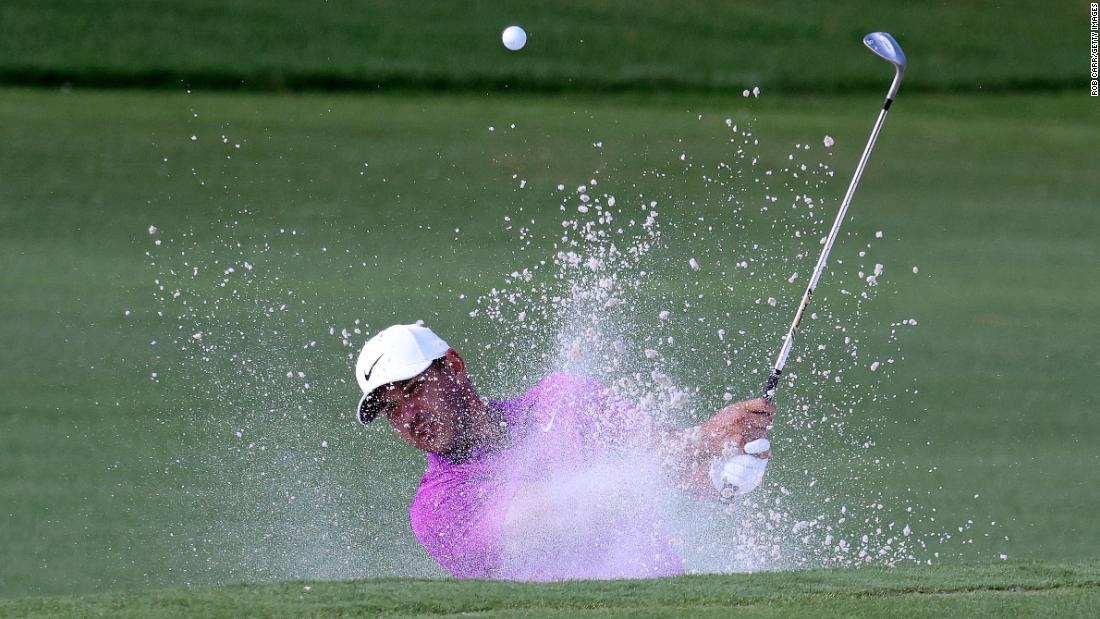 Brooks Koepka of the United States plays a shot from a bunker on the 17th hole.