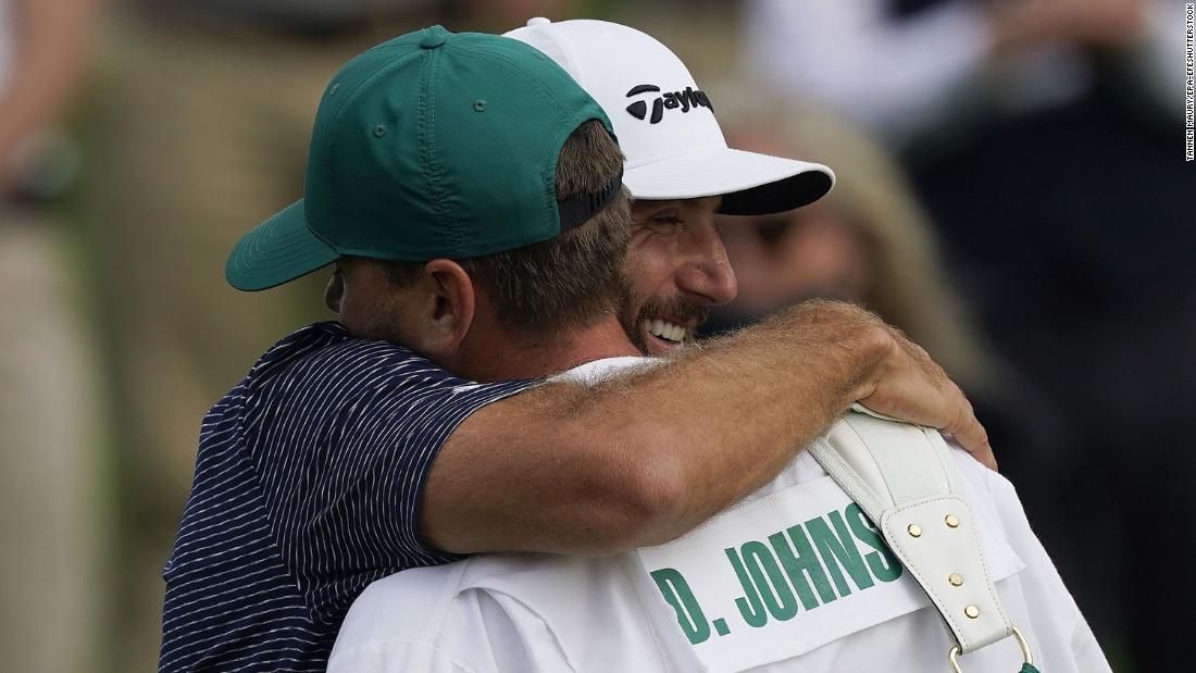 Dustin Johnson of the US embraces his caddie and brother Austin Johnson after sinking his putt to win on the 18th hole during the final round of the 2020 Masters. After being delayed seven months by the coronavirus pandemic, the 2020 Masters Tournament was held without patrons 12 November through 15 November.