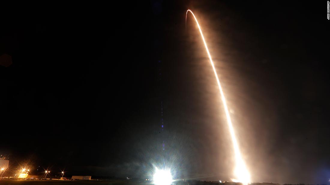 A Falcon 9 SpaceX rocket with the Crew Dragon capsule is seen in this  long-exposure photo as it lifts off from Kennedy Space Center.