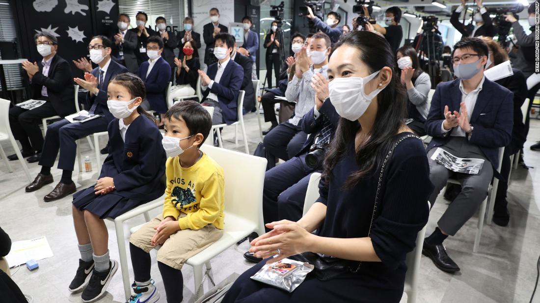 People watch the Crew Dragon launch in Tokyo on November 16.