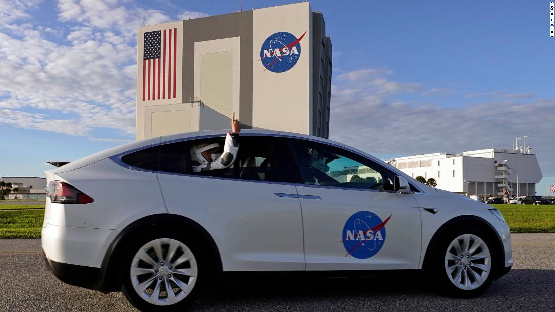 Noguchi sticks his arm out the window while riding to Launch Pad 39A for liftoff.