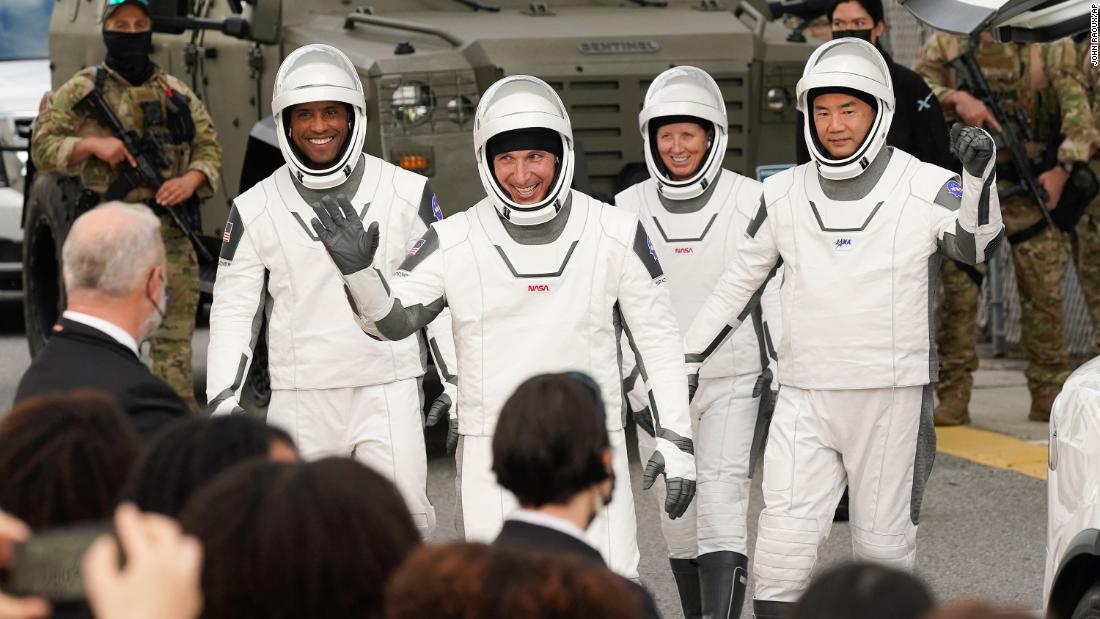 Glover, Hopkins, Walker and Noguchi wave as they leave the Operations and Checkout Building.