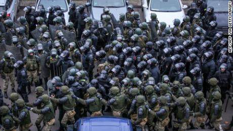 Law enforcement officers gather to disperse opposition supporters during a rally to protest against the Belarus presidential election results in Minsk, on November 15.
