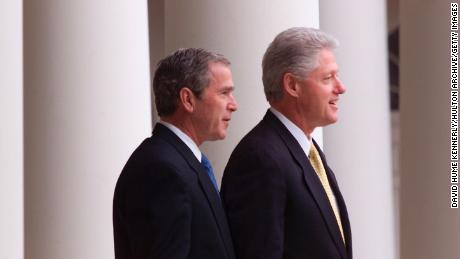 President Bill Clinton and President-elect George W. Bush stand outside the White House for their first meeting since the election December 19, 2000, in Washington, D.C. 