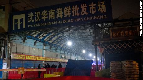 Security guards stand in front of the closed Huanan Seafood Wholesale Market in the city of Wuhan, in the Hubei Province, on January 11.