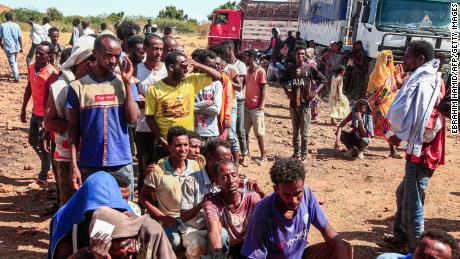 Ethiopian refugees fleeing fighting in Tigray province line up to receive supplies at the Um Rakuba camp in Sudan&#39;s eastern Gedaref province, on November 16.