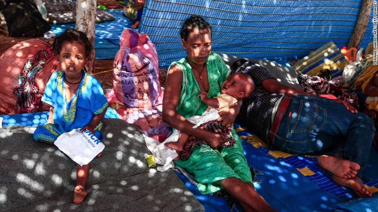 An Ethiopian refugee holds a child as she sits in a hut at the Um Rakuba camp in Sudan's eastern Gedaref province on November 16.