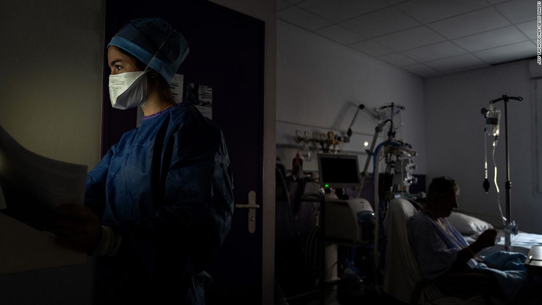 A medical worker looks away as she provides care to a Covid-19 patient in Saint-Etienne, France, on November 6.