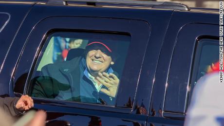 Trump waves to supporters protesting the results of the presidential election, as the presidential motorcade drives by the &quot;Million MAGA March&quot; rally, at Freedom Plaza in Washington on Saturday, November 14.