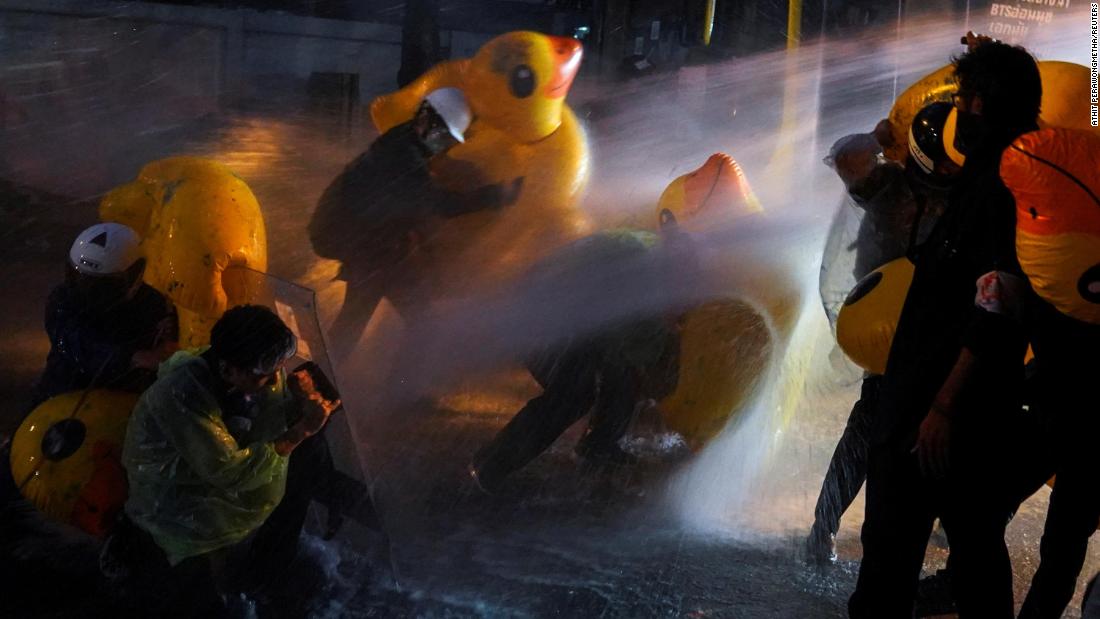 Demonstrators use inflatable rubber ducks as shields to protect themselves from water cannons during a demonstration outside the parliament in Bangkok, as lawmakers debate constitutional changes, on November 17.
