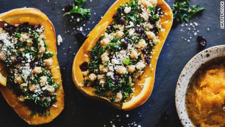 Stuffed squashes with quinoa, kale, cranberries, and chickpeas are a colorful addition to the holiday table.
