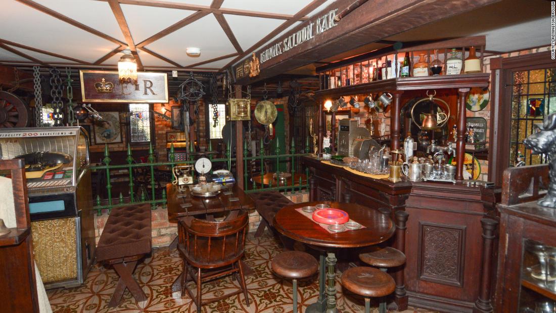 Alan Brough had modeled part of the room on a traditional British saloon bar. An antique Anker cash register sat on the counter surrounded by glassware and silver tankards.