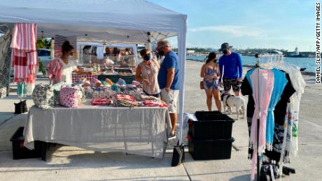 Customers and vendors wear masks at a farmers&#39; market in Key West, Florida, on September 17.