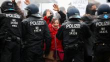Demonstrators put up their hands in front of police officers during a protest against the government&#39;s coronavirus restrictions in Berlin, November 18, 2020.