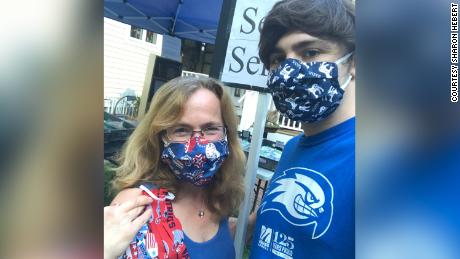 Sharon Hebert pictured with her son, Walter, wearing masks she sewed